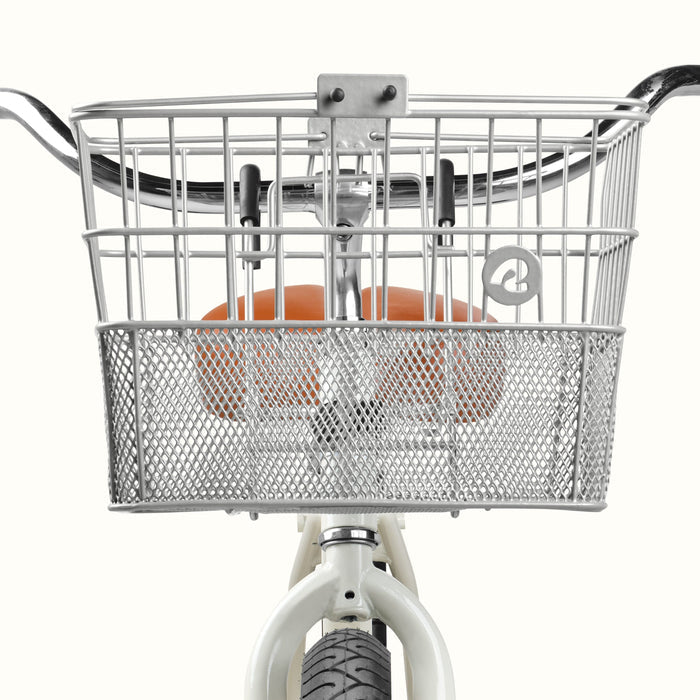 A silver wire basket mounted on a bicycle’s handlebars, paired with a white bike frame and black tire.