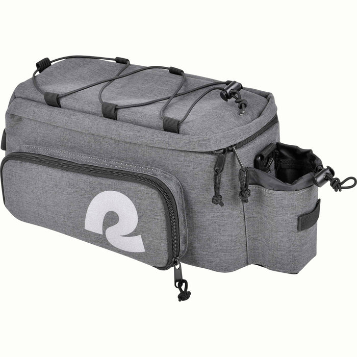 A gray heather bicycle trunk bag with a large white stylized reflective 'R' logo on the front pocket, top black bungee straps, and a side bottle holder, shown on a plain white background.
