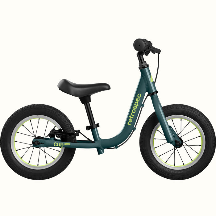 Green balance bike with white wheels on a white background.