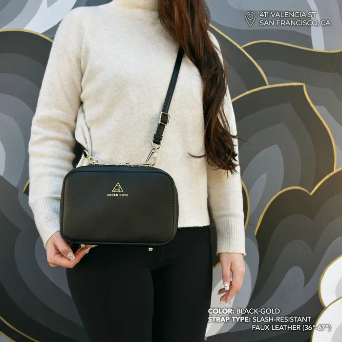 Anti-theft Water-resistant Travel Elise Crossbody in black and gold hardware with slash-resistant faux leather strap - modeled shot