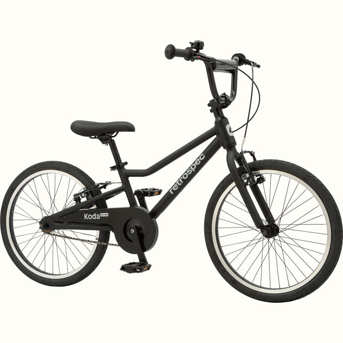Matte black kids' Koda Plus 20" Bike with black chain guard and black saddle on a white background.