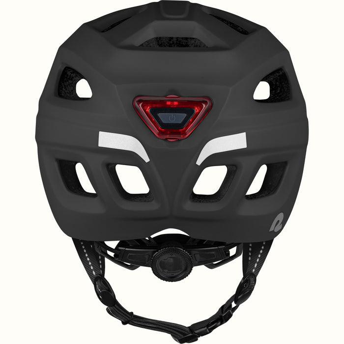 Rear view of a Lennon Commuter Bike Helmet in Matte Black, showing the integrated red LED safety light, reflective strips, ventilation ports, and adjustable dial fit system.