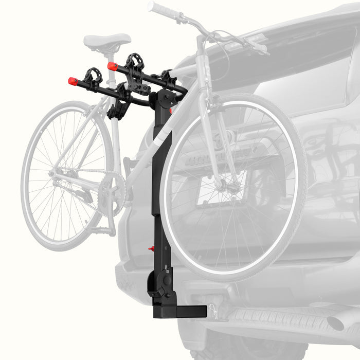 retrospec Lenox Plus Hitch Mount Car Bike Rack (2-Bikes) installed on an SUV with one bike secured in the padded frame cradles, shown from a rear three-quarter angle.