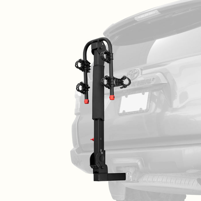 retrospec Lenox Plus Hitch Mount Car Bike Rack (2-Bikes)
installed on the rear of a Toyota 4Runner, shown empty in the folded upright position with cradle arms raised and red safety caps in place.