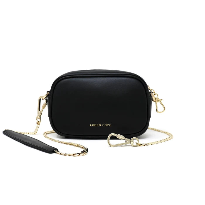 Anti-theft water-resistant Myko Crossbody in black with gold hardware with slash-resistant chain straps, front view