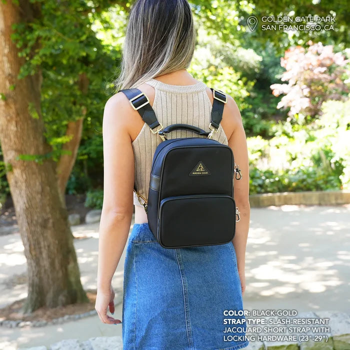 Model wearing Anti-theft Water-resistant Carmel convertible backpack in black/gold with slash-resistant jacquard straps