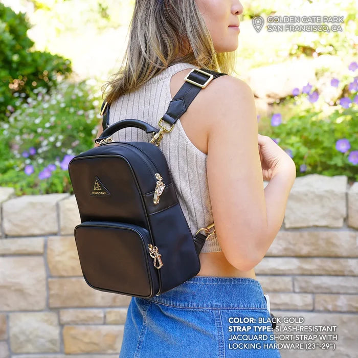 Model wearing Anti-theft Water-resistant Carmel convertible backpack in black/gold with slash-resistant jacquard straps