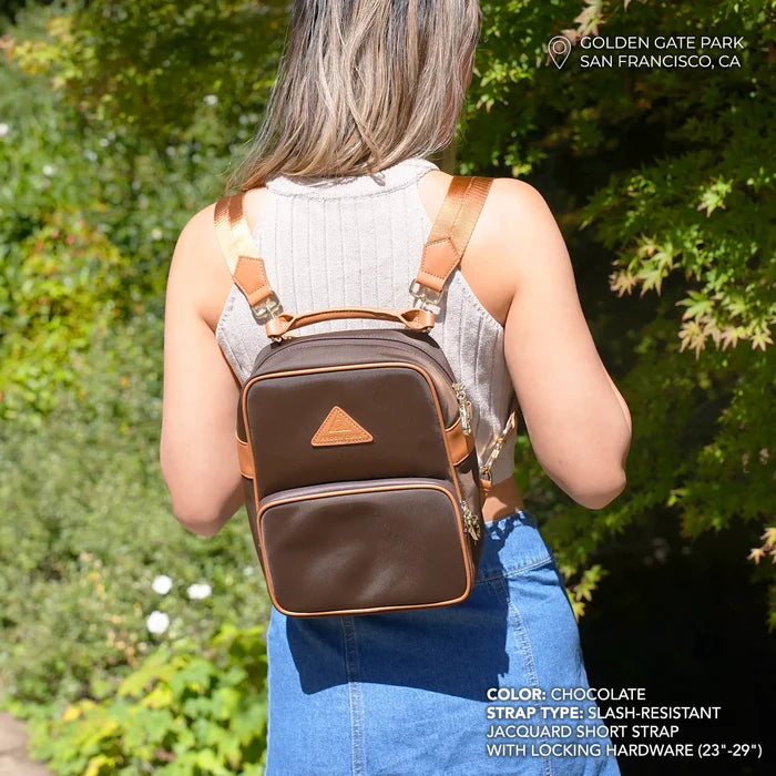 Model wearing anti-theft water-resistant Carmel convertible backpack in brown/gold with slash-resistant jacquard straps