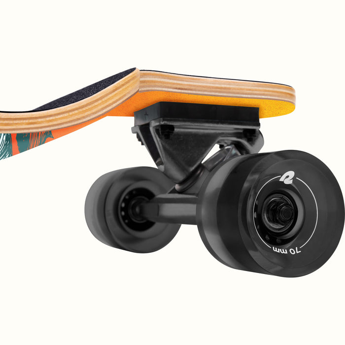 Close-up of the Tidal Drop Down Longboard showcasing the deck, grip tape, and black 70mm wheels attached to a sturdy truck.