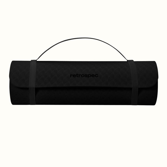 Black rolled-up yoga mat with carrying strap and "retrospec" logo on a white background.